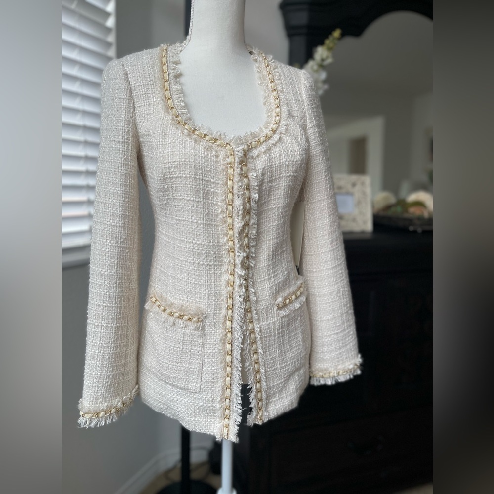 Tweed blazer with gold chain trim.